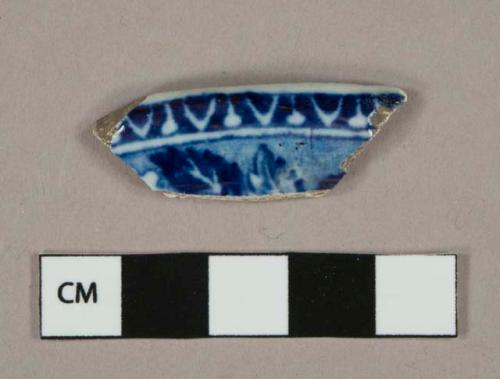 Blue on white transferprinted earthenware vessel body fragment, possible lid, white paste, lead glazed