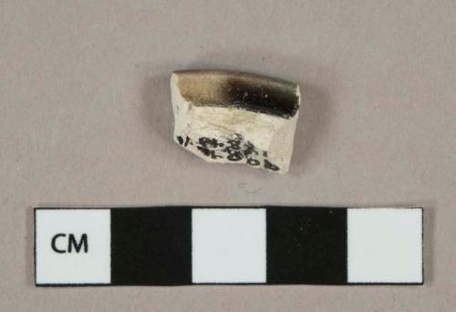 Dark brown and cream mottled lead glazed earthenware vessel rim fragment, white paste, likely rockingham type