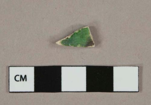 Green and brown mottled lead glazed earthenware vessel body fragment, light buff paste, rockingham type