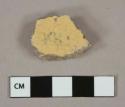 Undecorated yellow lead glazed earthenwear vessel body fragment, buff paste