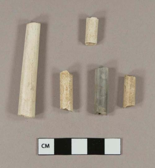 Unsmoked, undecorated pipe stem fragments; one fragment 4/64" bore diameter; two fragments 5/64" bore diameter; one fragment 6/64" bore diameter; smoked, undecorated pipe stem fragment; 5/64" bore diameter