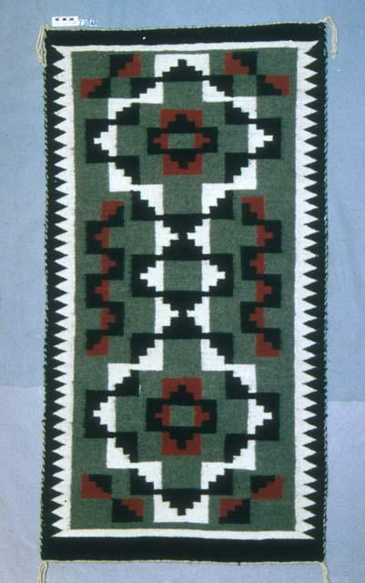 Klagetoh rug with interlaced black and white diamond forms