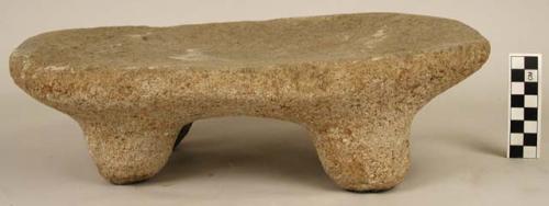 One four legged stone metate