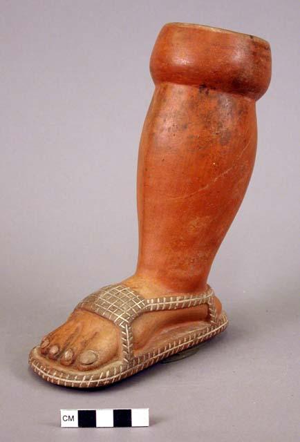 Pot in shape of human foot and leg