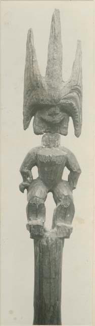Carved wooden staff with anthropomorphic figure, front