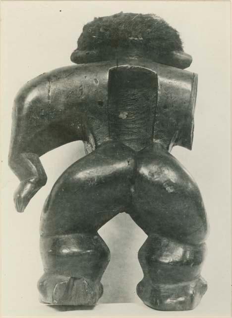 Carved wooden anthropomorphic figure with hair, back