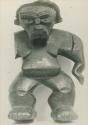 Carved wooden anthropomorphic figure with hair, front