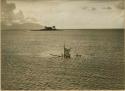 Men in capsized canoe