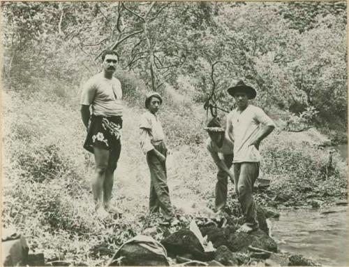 Men on lake shore