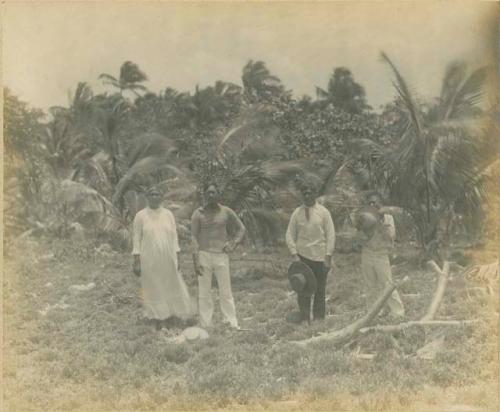 Woman and three men in clearing