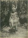 Girl in dress made of palm fronds and grasses