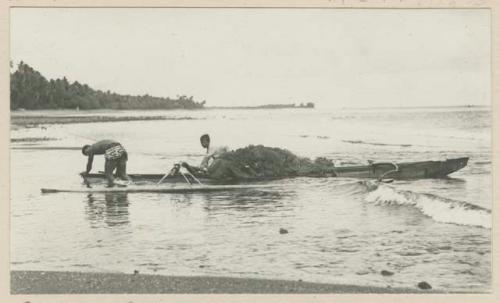 Fishermen in outrigger canoe