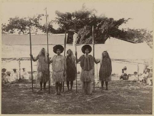 Men with spears in traditional Tahititan dress