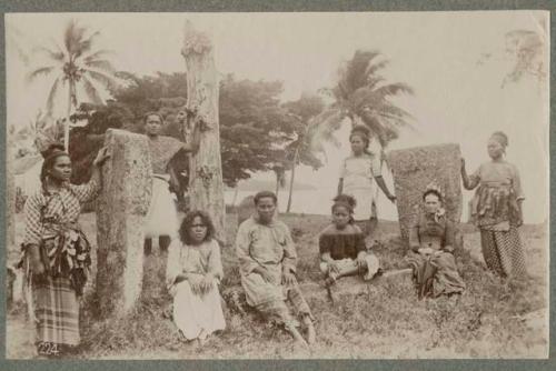 Group of people next to stones and stumps