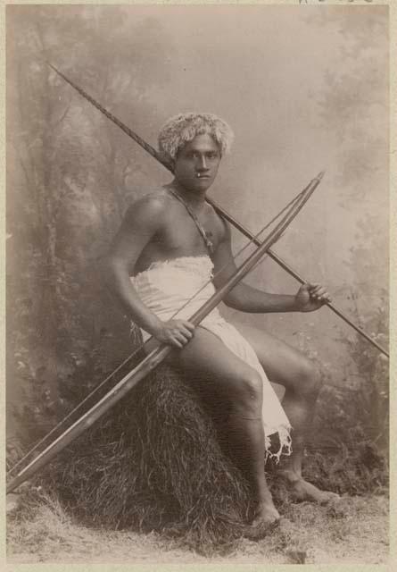 Studio portrait of man with bow and arrow