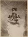 Studio portrait of woman with fan