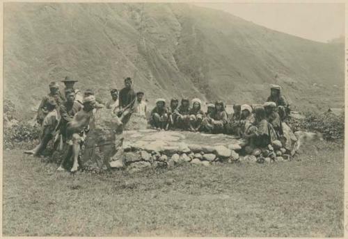 Group of Igorot men and women, stone court