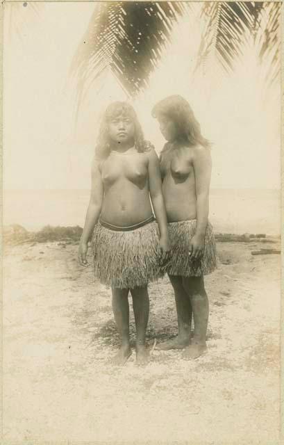 Two women standing on beach