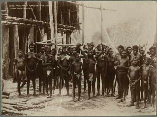 Large group of people in front of a wooden structure