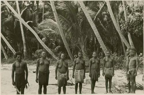 Group of women standing in front of palms