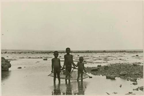 Children on the shore with fishing nets