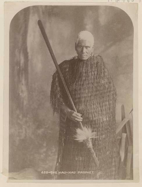 Studio portrait of old man with spear