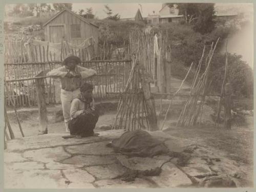 Couple cooking, neighborhood in background