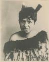 Head portrait of Ngamako with two feathers in her hair