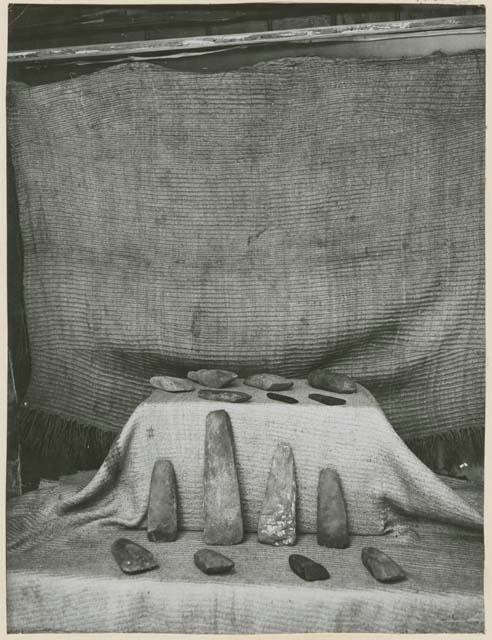 Two Korowai mats with stone adzes and chisels