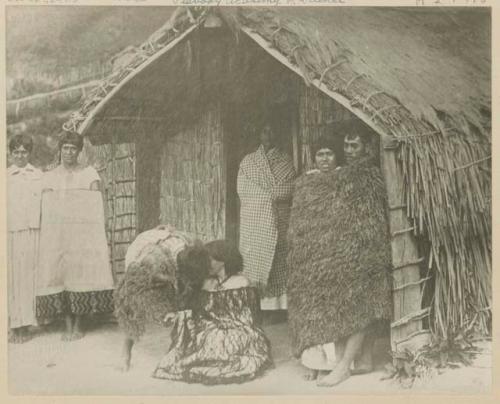 People standing outside house