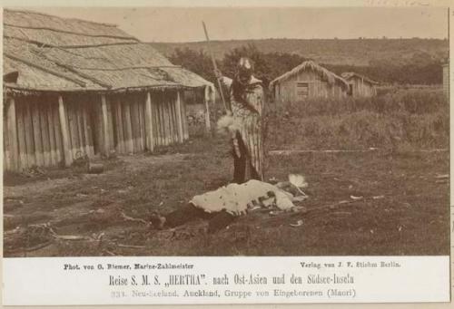 Maori man standing over another outdoors