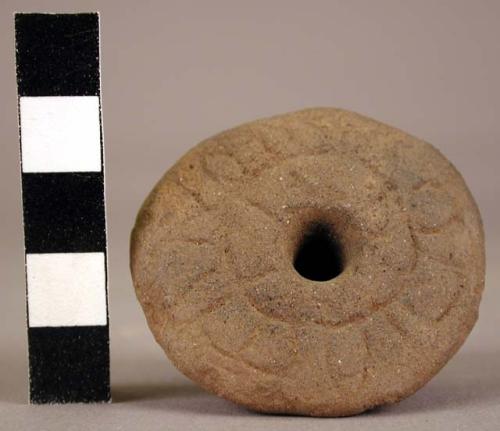 Pottery spindle whorl, incised on flat side