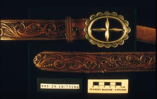 Silver sandcast belt buckle on tooled leather belt