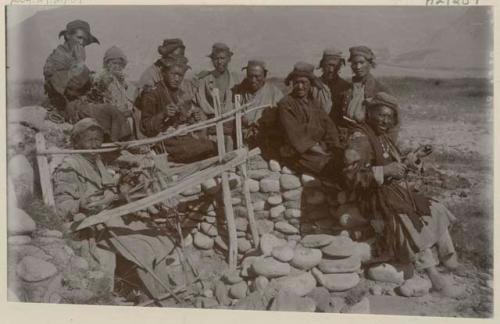 Group of weavers with a loom and spindles