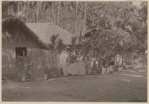 Group standing next to a fence and buildings