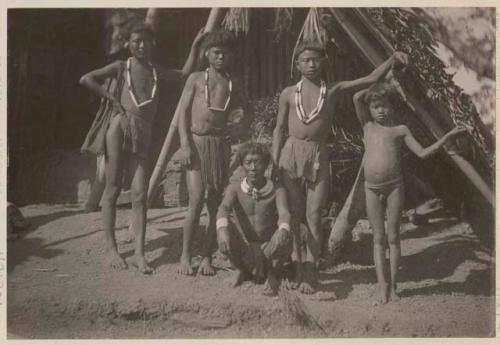 Man and boys in front of a structure