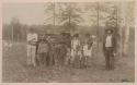 Men, women, and children in front of train