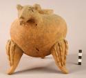 Large tripod pottery jar with rattle legs and modelled head & tail of animal at