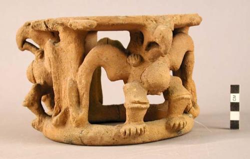 Pottery stand, Chiriqui type.  Anthropomorphic figures which are rattles.  Light