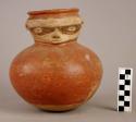 Pottery effigy jar, red body and neck