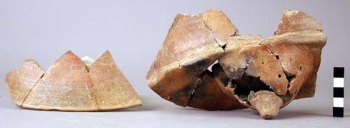 Rim, base, and body potsherds from tetrapod dishes - orange ware