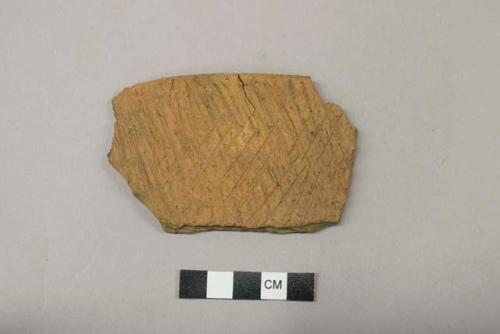 Archaeological, ceramics rim sherd, cross hatch design on exterior.