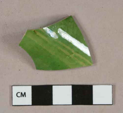 Green lead glazed earthenware vessel body fragment, buff paste, undecorated