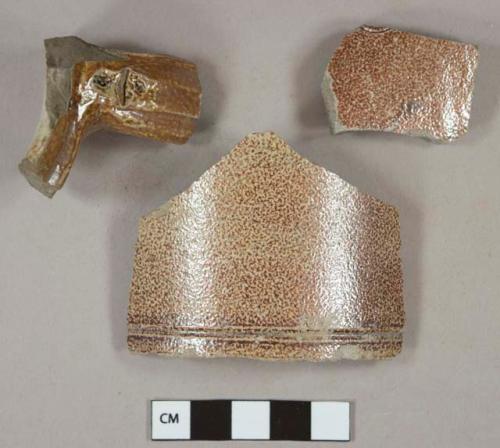 Brown salt glazed stoneware vessel body, rim, and handle fragments, gray paste