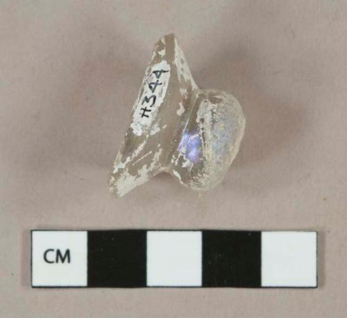 Colorless glass vessel fragment, likely lid knob or stemware fragment