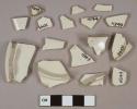 Undecorated white salt glazed stoneware vessel body, rim, and base fragments, light gray paste