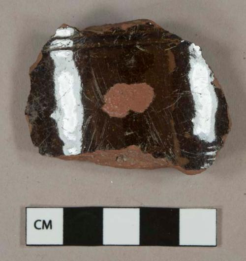 Dark brown lead glazed redware vessel body and rim fragments