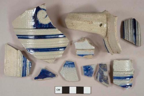 Gray salt glazed and cobalt decorated stoneware vessel body, rim, and handle fragments, gray paste, molded decoration, Westerwald type