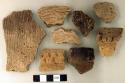 Coarse earthenware base, body, and rim sherds, many cord-impressed; stone fragments; skull fragment