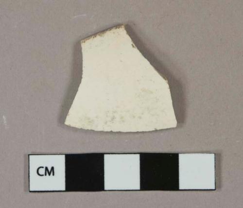 Undecorated whiteware vessel rim fragment, white or light buff paste